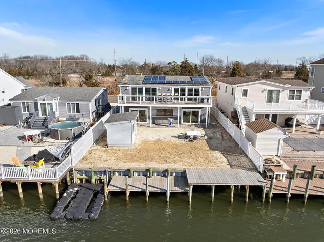 a view of a roof deck with table and chairs