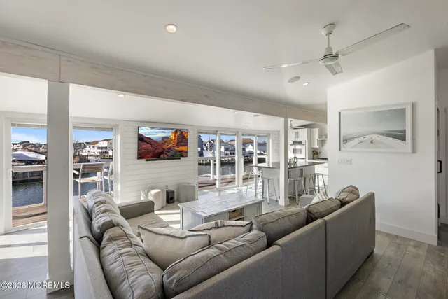 a living room with furniture and a floor to ceiling window