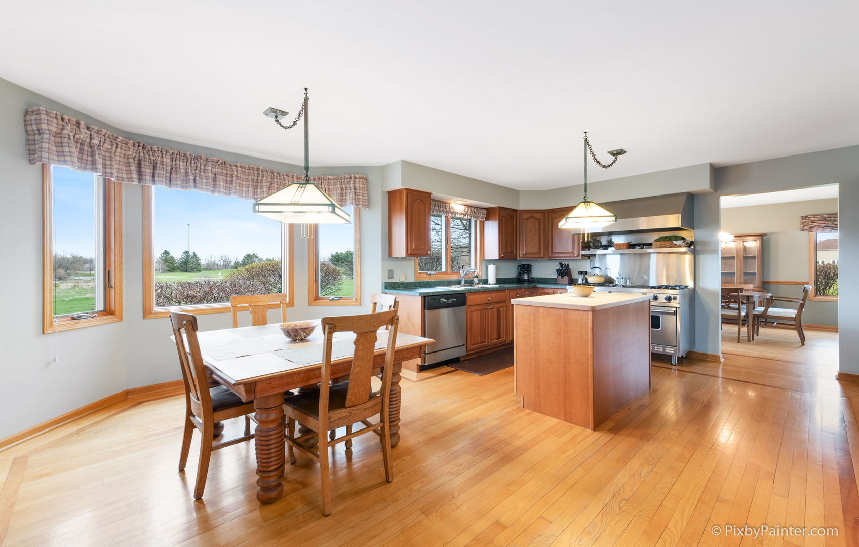 8214 Harmony Hill Road Marengo, IL 60152 - Photo 11 of 34 a view of a dining room and livingroom with furniture wooden floor a chandelier