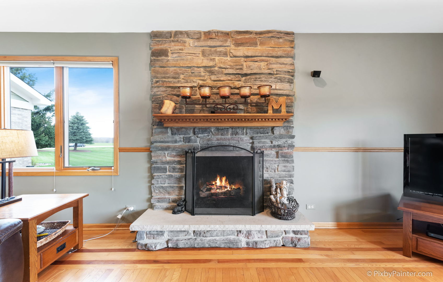 8214 Harmony Hill Road Marengo, IL 60152 - Photo 17 of 34 a living room with a fireplace a flat screen tv and a fireplace