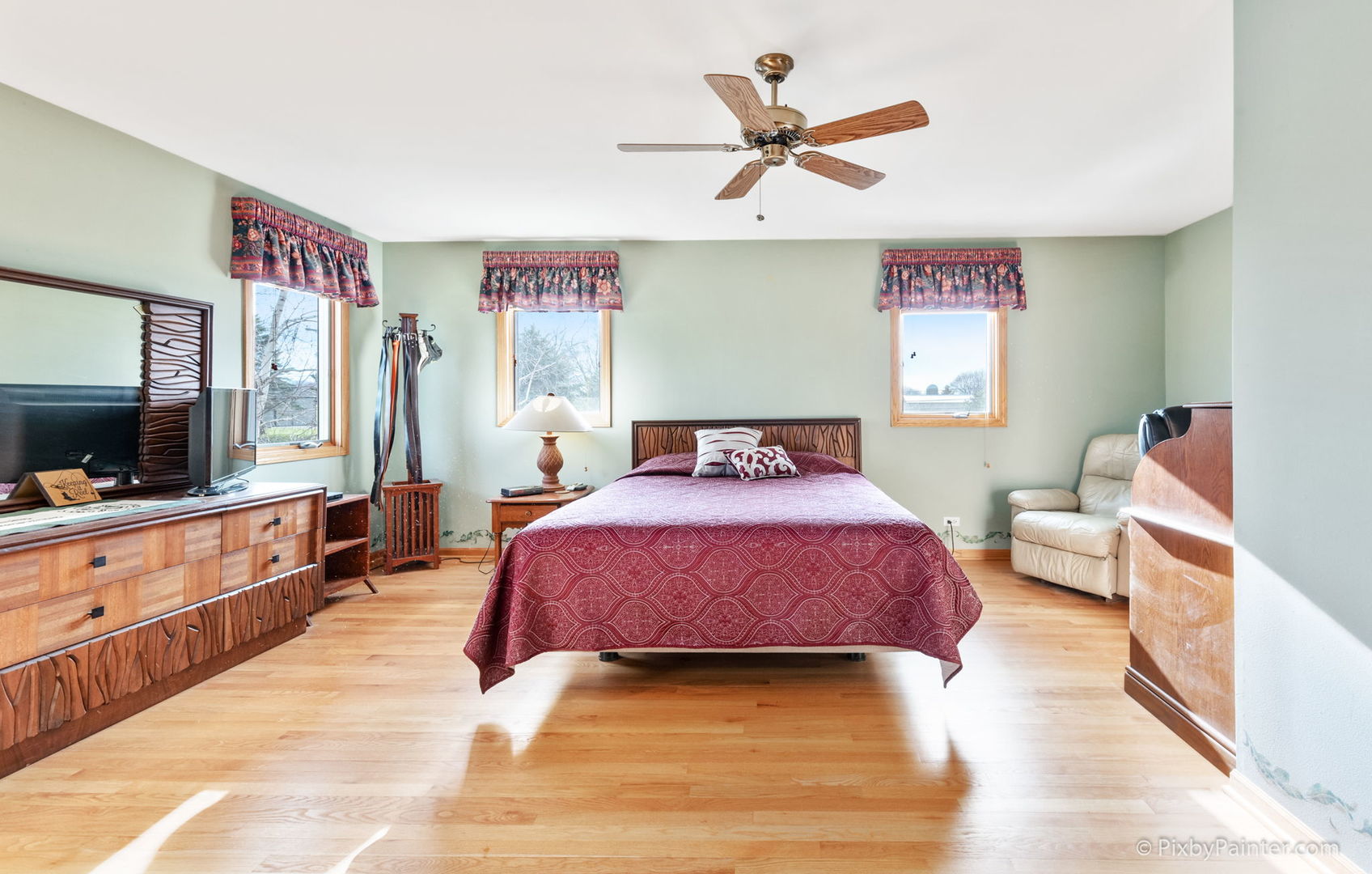 8214 Harmony Hill Road Marengo, IL 60152 - Photo 24 of 34 a bedroom with a bed and a chandelier