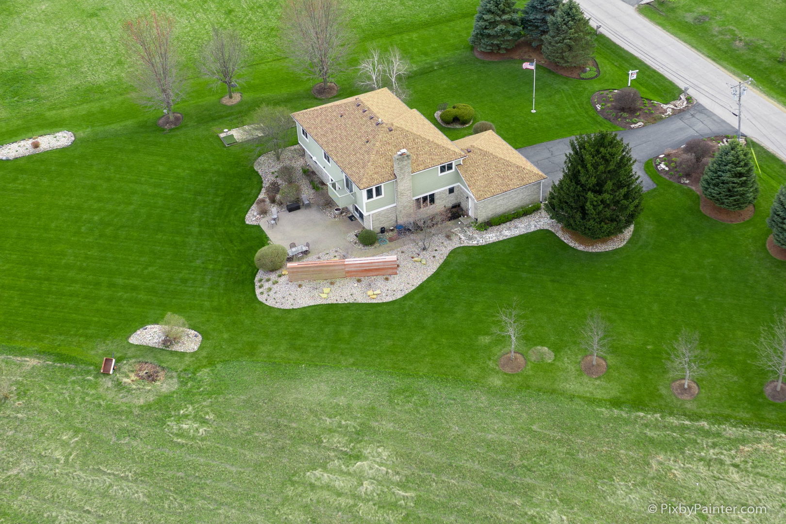 8214 Harmony Hill Road Marengo, IL 60152 - Photo 32 of 34 a white house with a white bed and a yard