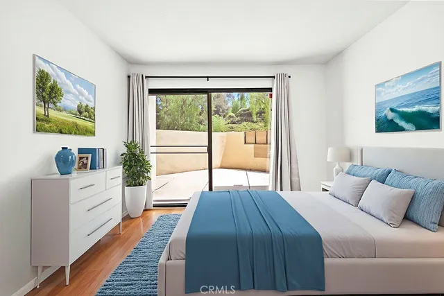 a bedroom with a large bed and a large window