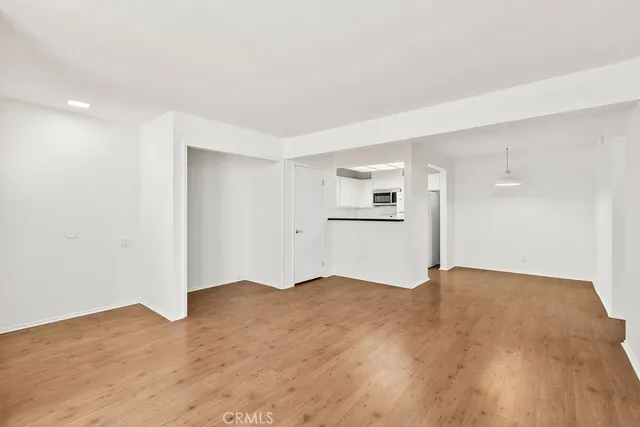 a view of a room with wooden floor and a sink