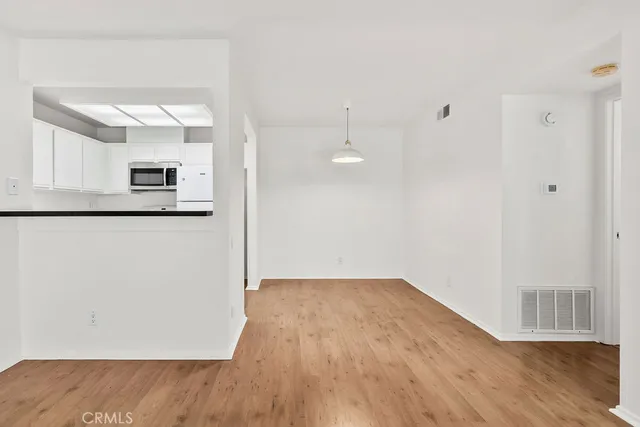 a kitchen with white cabinets and a sink