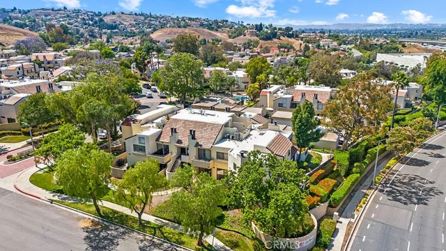 an aerial view of residential house with outdoor space and trees all around