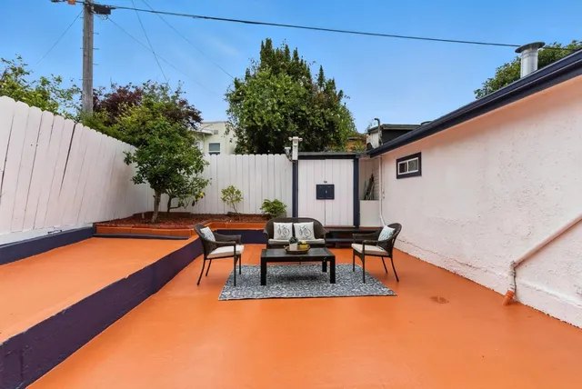 a bedroom with a bed and painting on the wall