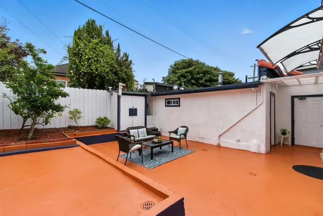 a backyard of a house with yard and outdoor seating