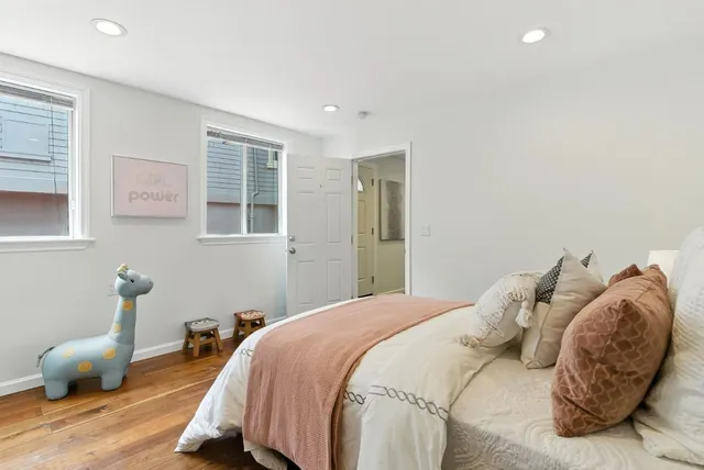 a bedroom with a bed and a night stand