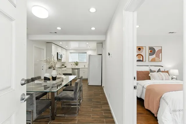 a bedroom with furniture and a wooden floor