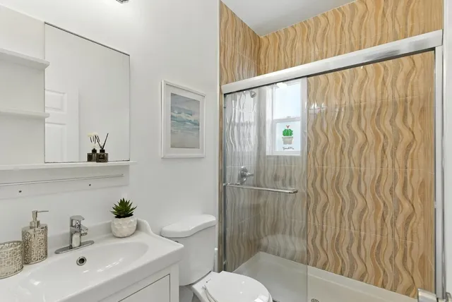 a bedroom with a bed mirror and window