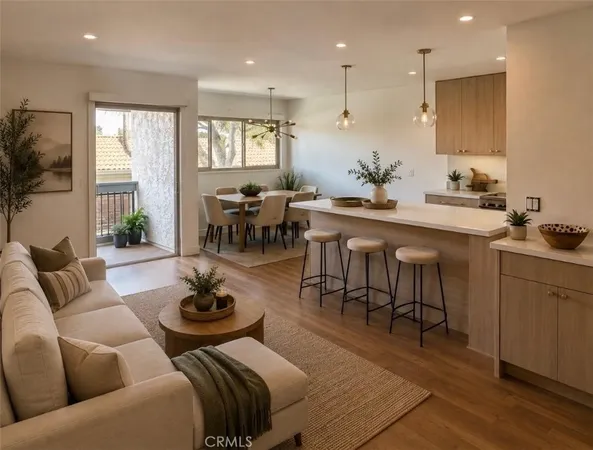 a living room with furniture kitchen and a table