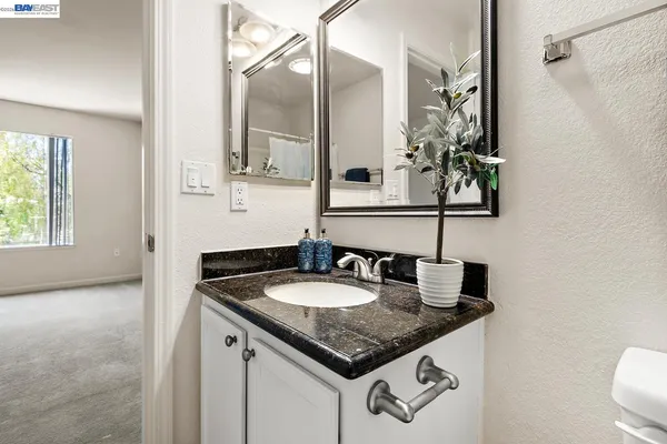 an empty room with closet and a bathroom