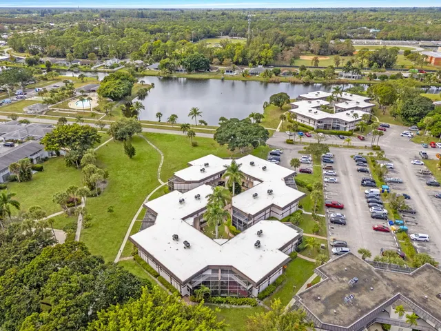 an aerial view of a house with a lake view