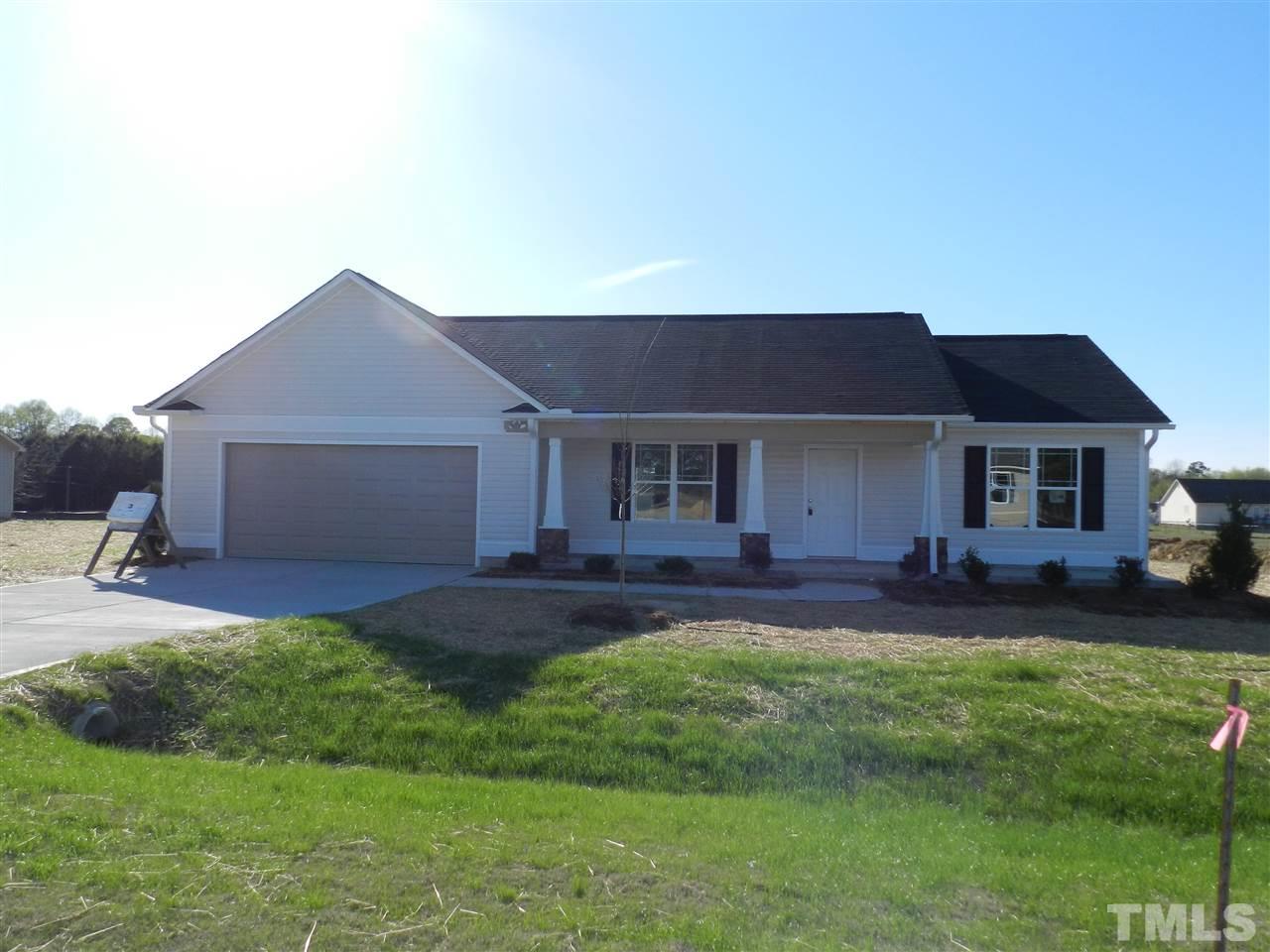69 Willow Ridge Circle Willow Spring, NC 27592 - Photo 1 of 8 a front view of a house with a garden and yard