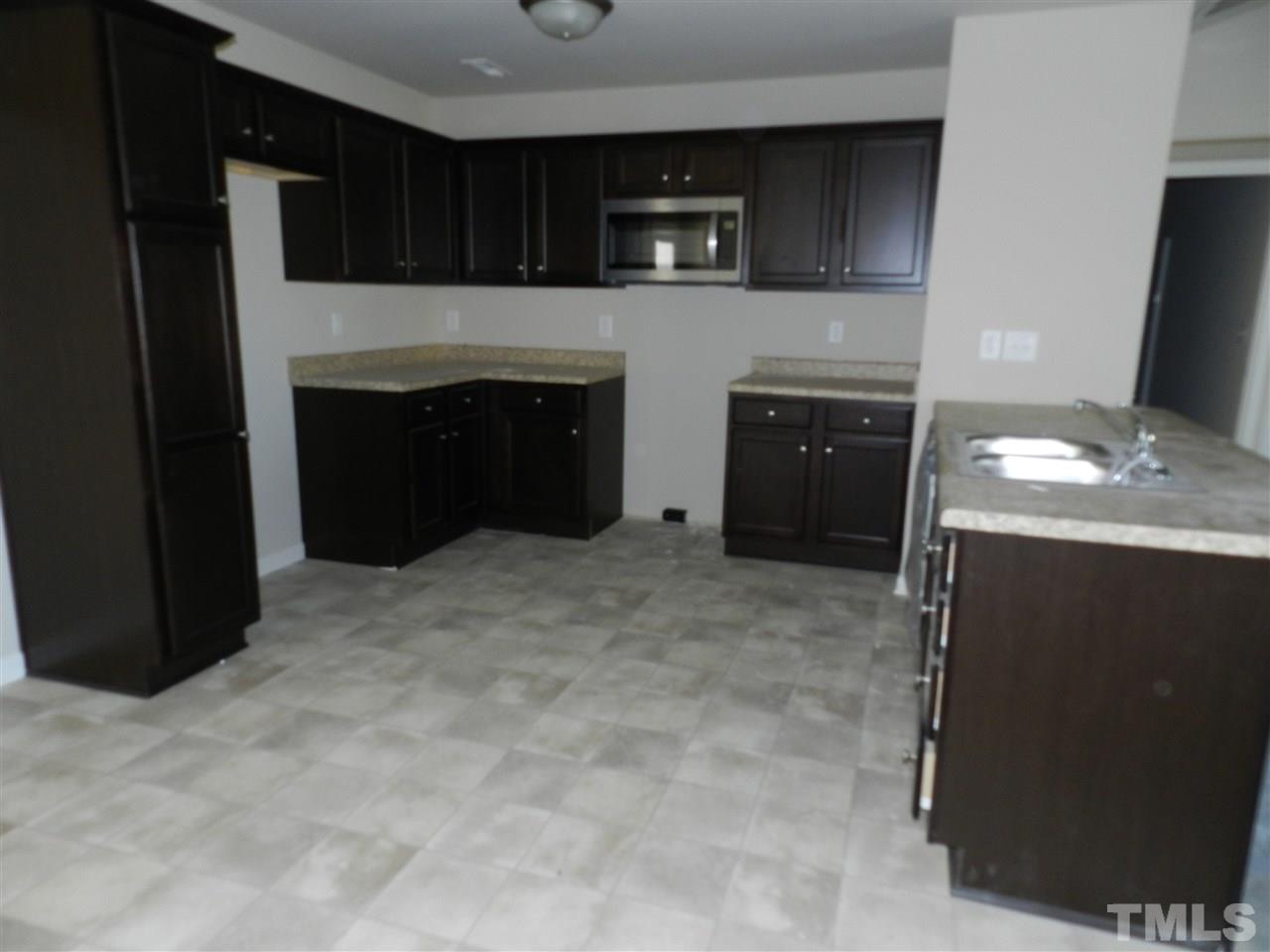 69 Willow Ridge Circle Willow Spring, NC 27592 - Photo 4 of 8 a kitchen with a stove and a refrigerator