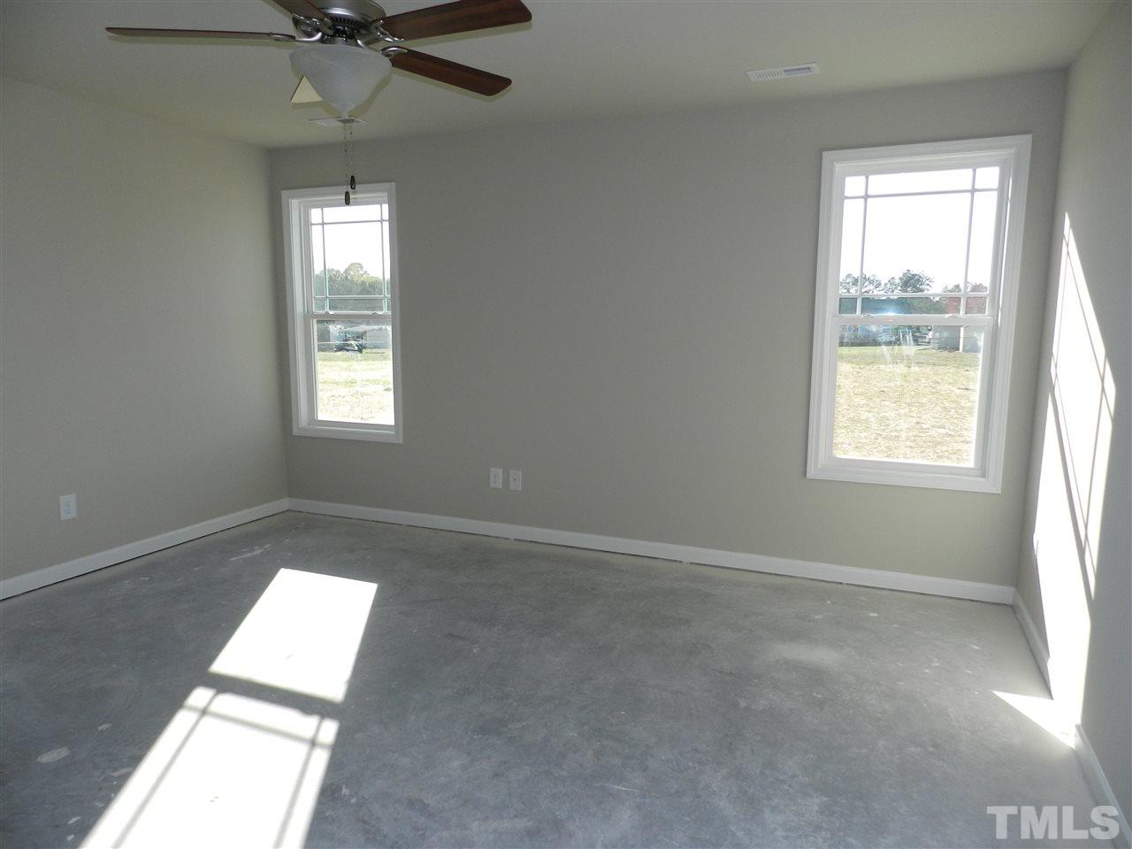 69 Willow Ridge Circle Willow Spring, NC 27592 - Photo 5 of 8 an empty room with windows