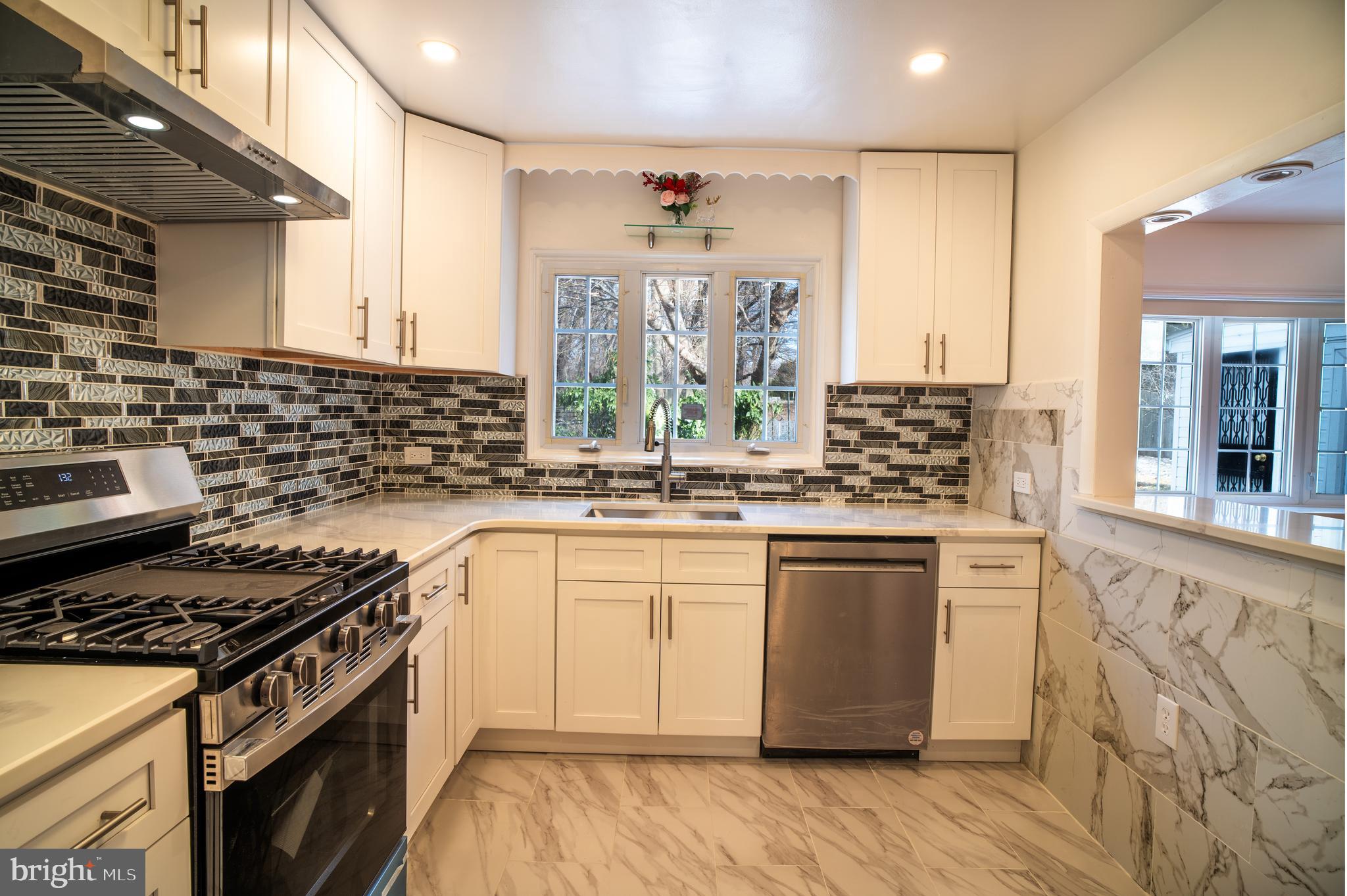 11 Wharton Lane Cheltenham, PA 19012 - Photo 11 of 17 a kitchen with stainless steel appliances granite countertop a stove and a sink