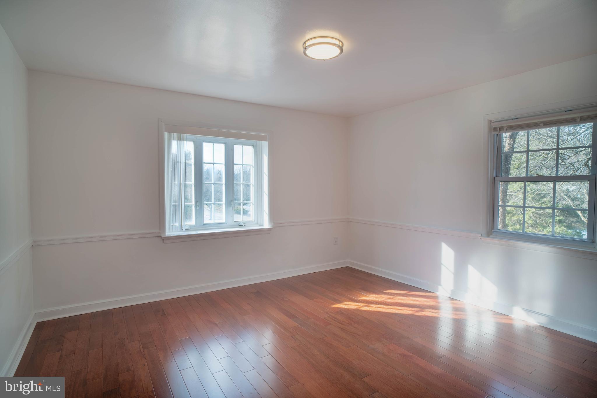 11 Wharton Lane Cheltenham, PA 19012 - Photo 12 of 17 an empty room with wooden floor and windows