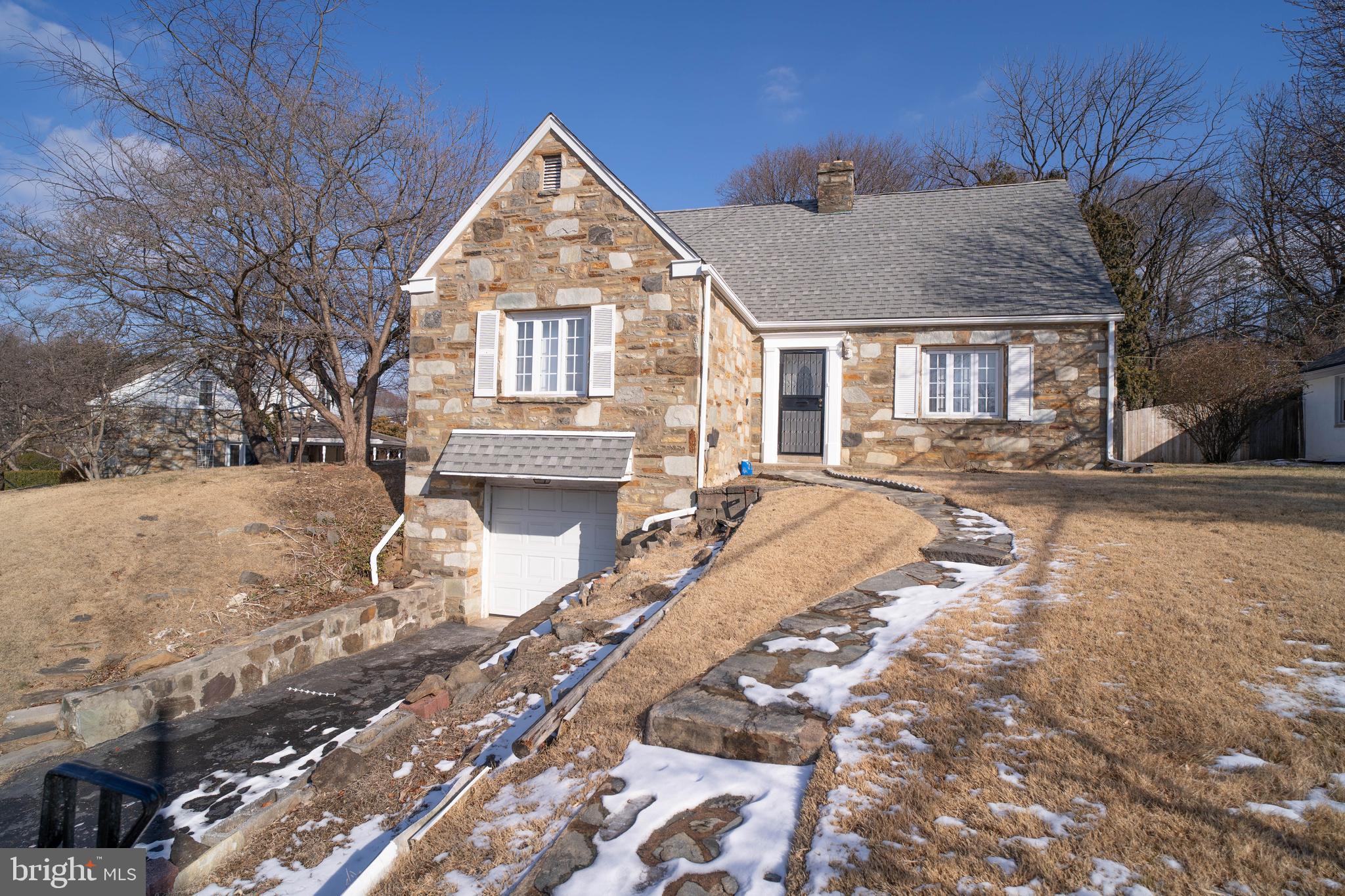 11 Wharton Lane Cheltenham, PA 19012 - Photo 2 of 17 a front view of a house with a yard covered with snow