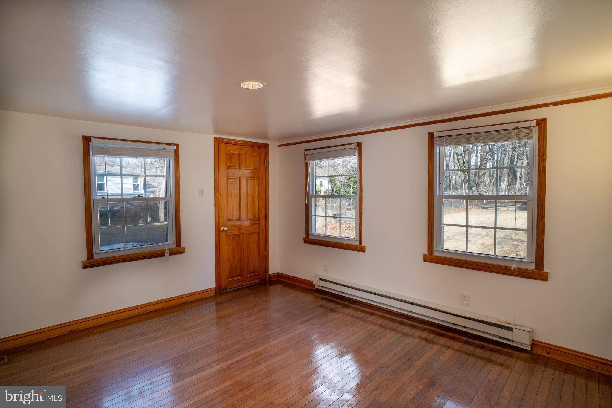 11 Wharton Lane Cheltenham, PA 19012 - Photo 8 of 17 an empty room with wooden floor and windows