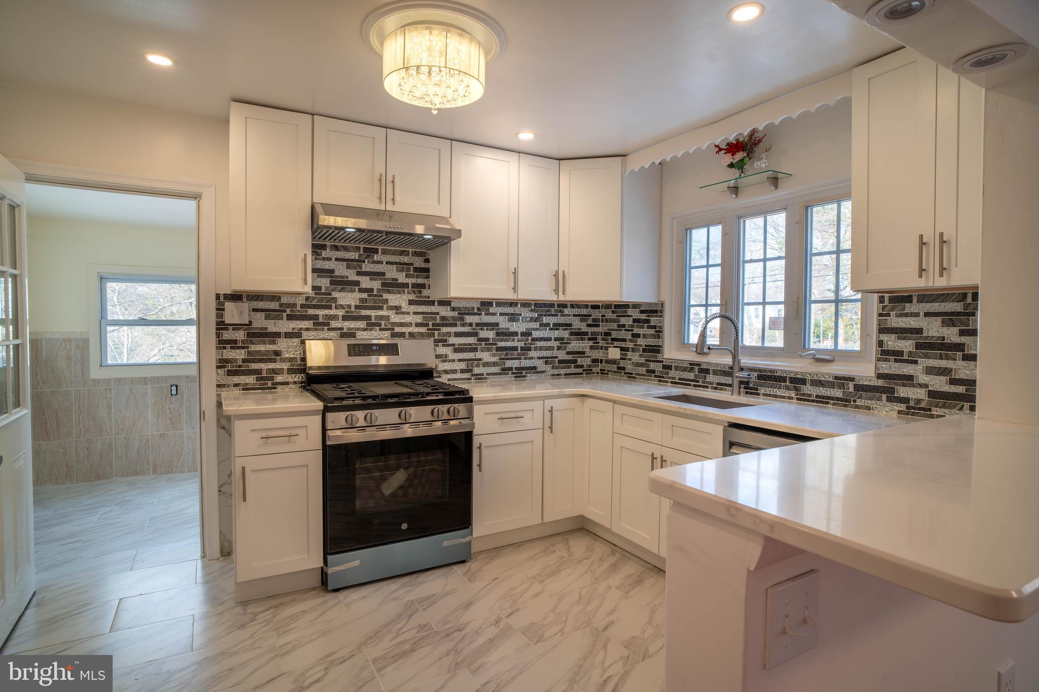 11 Wharton Lane Cheltenham, PA 19012 - Photo 10 of 17 a kitchen with granite countertop a stove and a sink