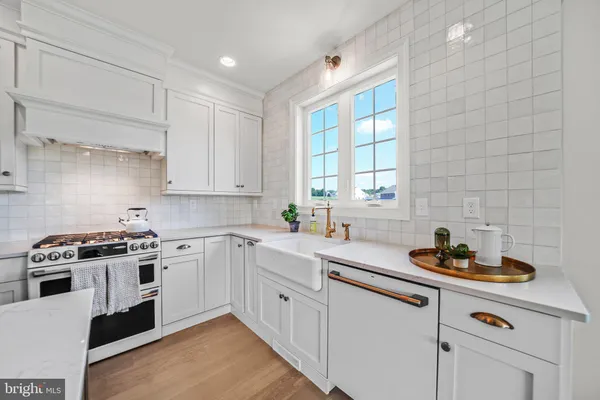 a kitchen that has a sink and a stove