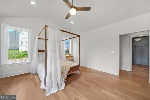 a bedroom with a bed and a view of room