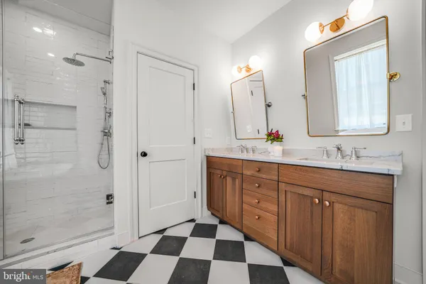 a bathroom with a sink a mirror and a shower