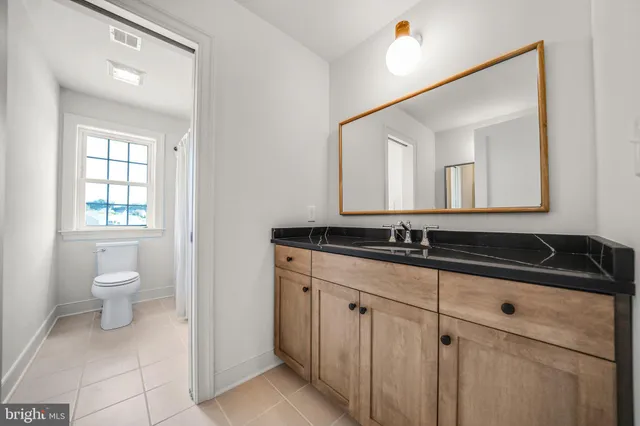 an empty room with wooden floor and window