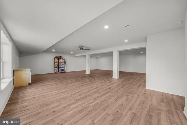 a view of a livingroom with a stove and wooden floor