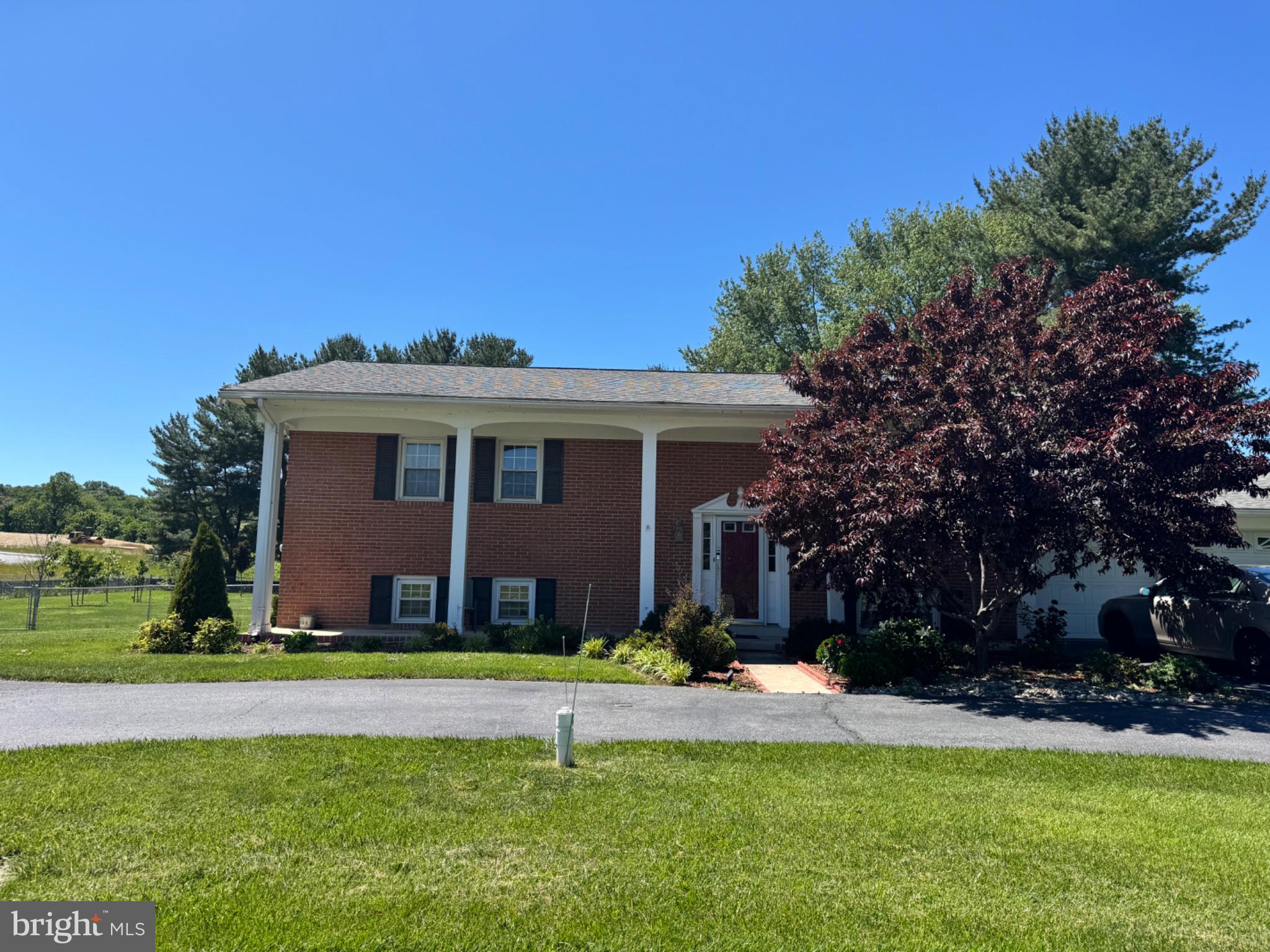 6742 Mt Phillip Road Frederick, MD 21703 - Photo 2 of 27 Charming brick home with lush greenery.