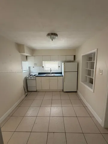 a kitchen with a cabinets and window