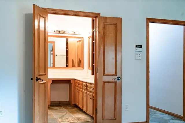 a view of walk in closet with empty room