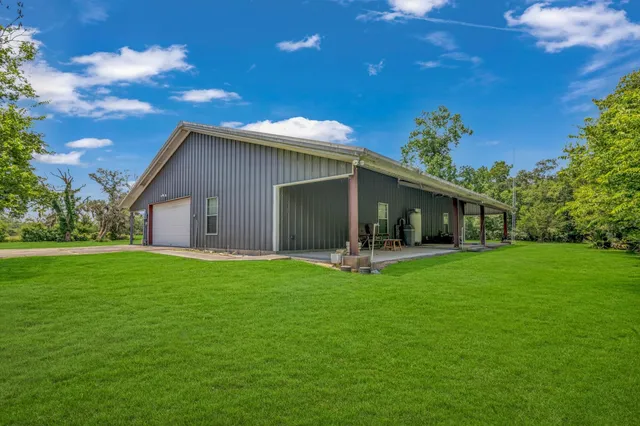a front view of house with a garden and trees