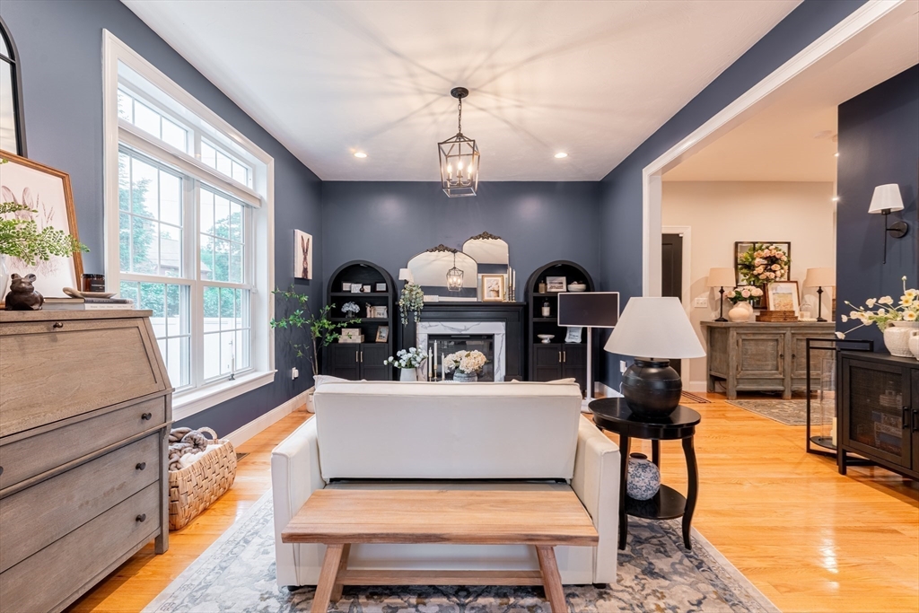 38 Cherry Street, Unit B Hudson, MA 01749 - Photo 13 of 33 a living room with furniture a fireplace and chandelier