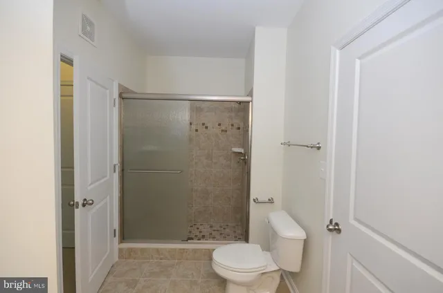 a bathroom with a shower and a toilet
