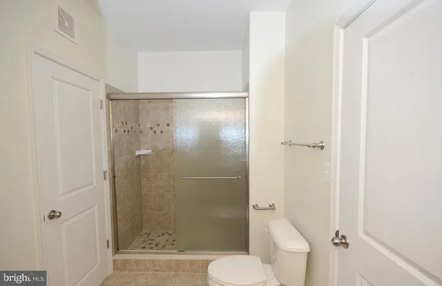 a bathroom with a shower and a toilet