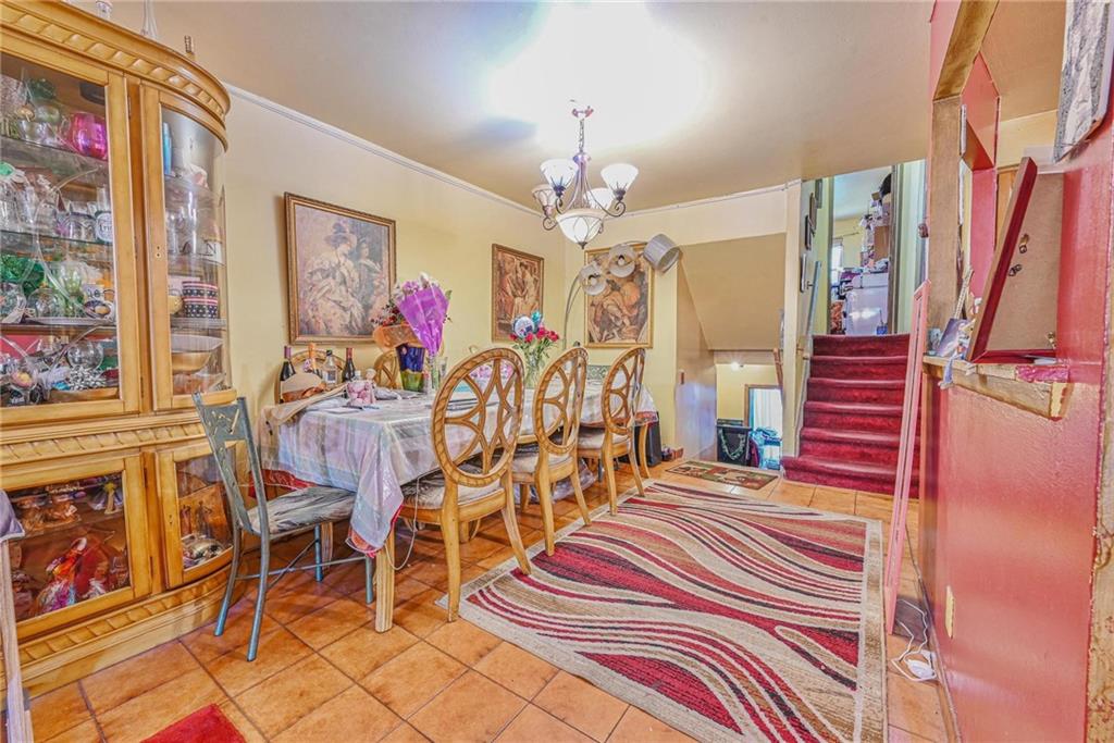 237 74th Street Brooklyn, NY 11209 - Photo 11 of 20 a bedroom with furniture and a chandelier