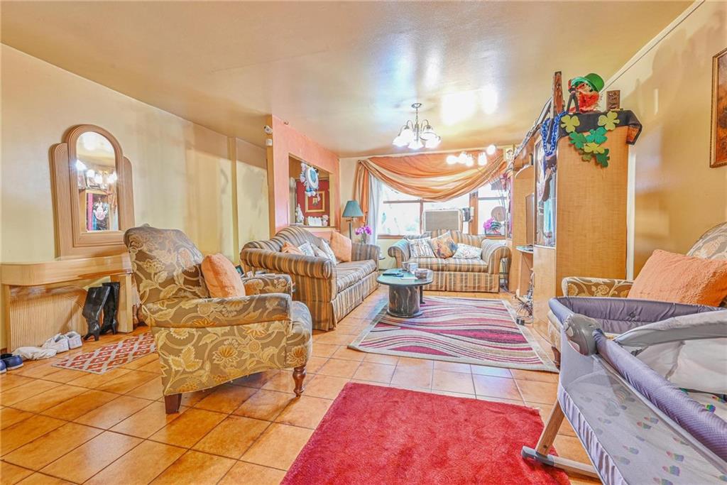 237 74th Street Brooklyn, NY 11209 - Photo 12 of 20 a bedroom with furniture and a chandelier