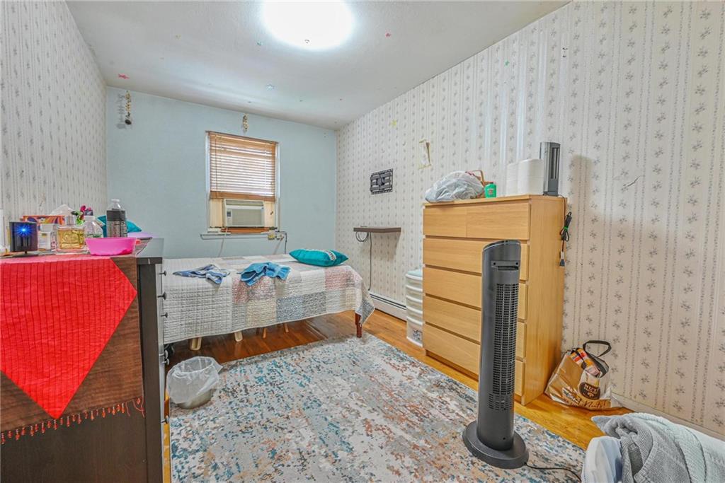 237 74th Street Brooklyn, NY 11209 - Photo 13 of 20 a bedroom with a bed and a window
