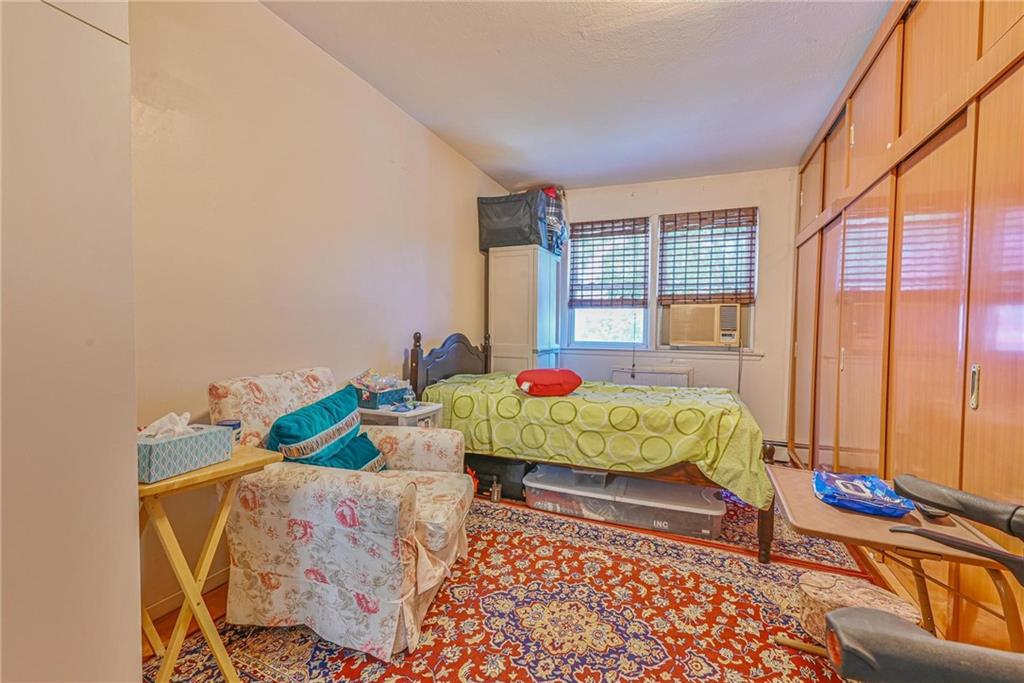 237 74th Street Brooklyn, NY 11209 - Photo 14 of 20 a bed sitting in a bedroom next to a window