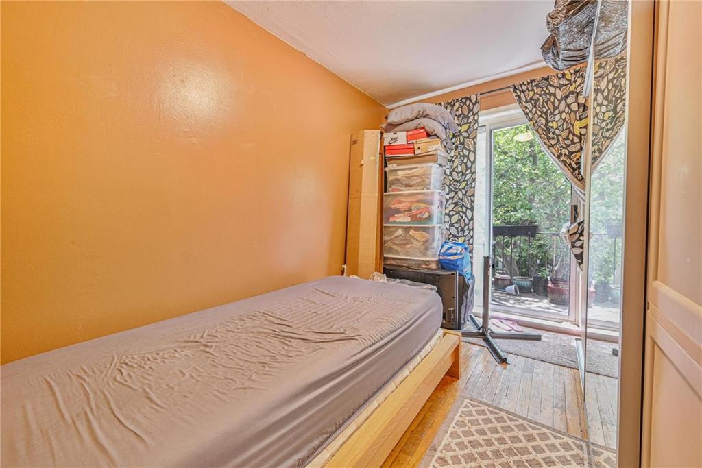 237 74th Street Brooklyn, NY 11209 - Photo 16 of 20 a bedroom with a bed and a window
