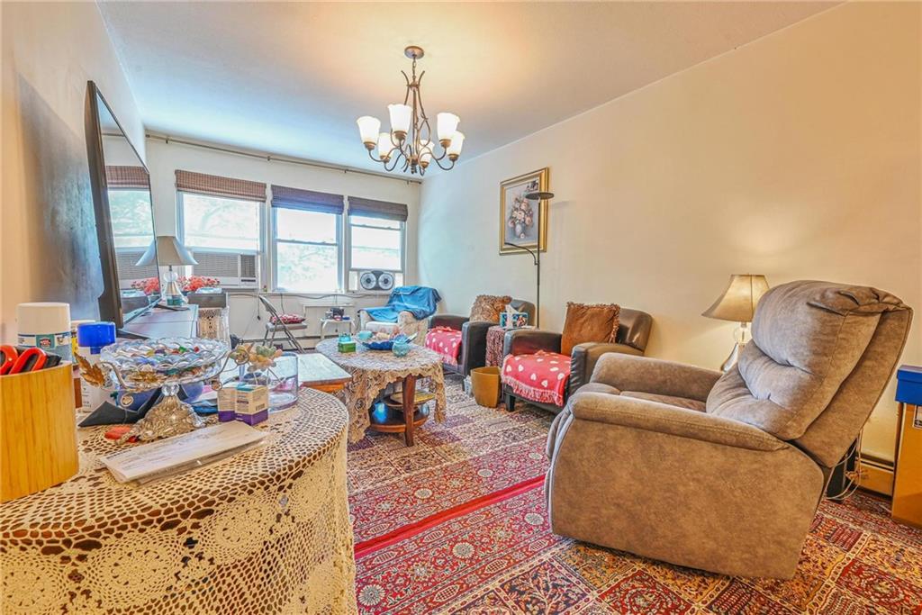 237 74th Street Brooklyn, NY 11209 - Photo 2 of 20 a living room with furniture chandelier and a chandelier