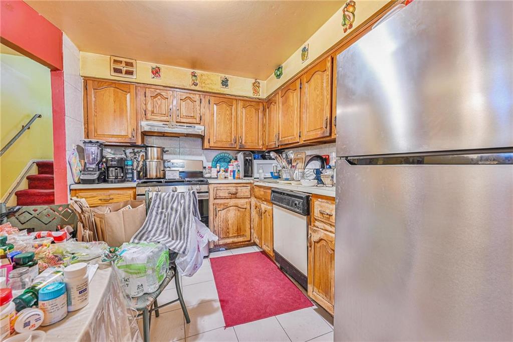 237 74th Street Brooklyn, NY 11209 - Photo 3 of 20 a kitchen with stainless steel appliances granite countertop a refrigerator a sink and a stove