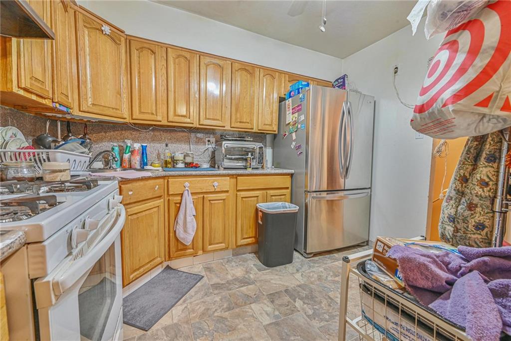 237 74th Street Brooklyn, NY 11209 - Photo 5 of 20 a kitchen with stainless steel appliances granite countertop a refrigerator a stove a sink and dishwasher