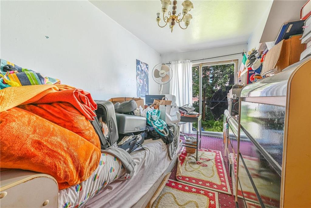 237 74th Street Brooklyn, NY 11209 - Photo 6 of 20 a living room with furniture a rug and a chandelier