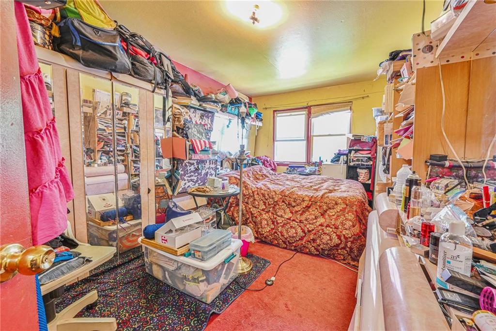 237 74th Street Brooklyn, NY 11209 - Photo 7 of 20 a bed room with a bed and a couch