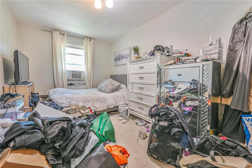 237 74th Street Brooklyn, NY 11209 - Photo 8 of 20 a bed room with a bed and a tv