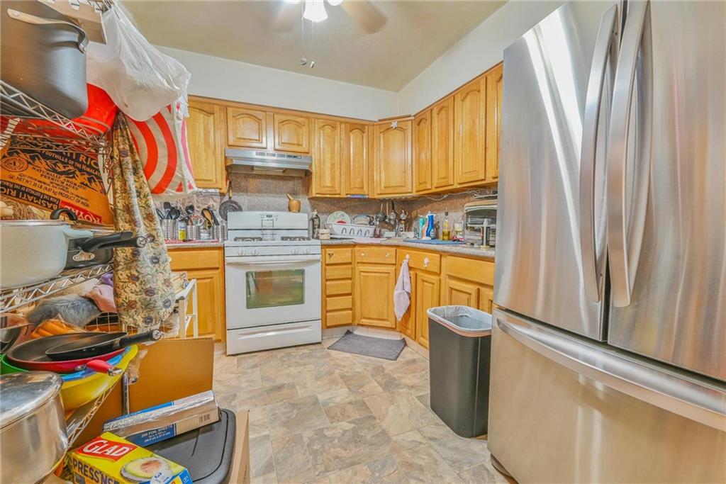 237 74th Street Brooklyn, NY 11209 - Photo 10 of 20 a kitchen with a sink stove and cabinets